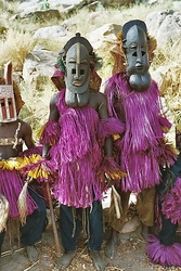 Dogon men in their ceremonial attire by Devriese via Flickr and Wikimedia.