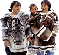 Iglulingmiut Inuit women and child in traditional parkas.