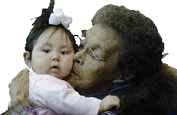 Iñupiat woman sharing a kunik with a small child at a Nalukataq in Utqiaġvik, Alaska.