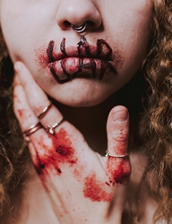 Unrecognizable woman with bloody wounds with word liar on lips by lil artsy via Pexels.com.