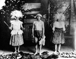 Herbert Young (Mountain Maidu and Mechoopda), George Nye (Nisenan Maidu), and Dewey Conway (Mechoopda) in "Big Head" dance costume traditional of the Maidu.