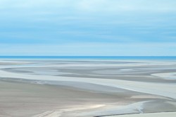 Grey sand dunes under blue sky by Jarosław Miś via Pexels.com.
